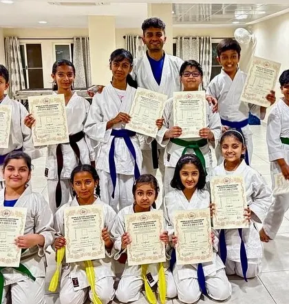 A group of proud students from our PFC, Purva Belmont, and Mahavir Palms dojos pose with their Sensei after receiving their new belts and certificates.