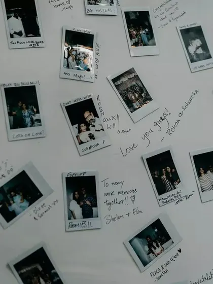 "Love you guys!" A close-up of the sweet, handwritten notes and candid polaroids that filled the couple's guest book board.