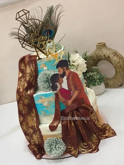 I had the honor of creating this divine Radha Krishna themed cake for an engagement. It features a beautiful illustration of the couple, peacock feathers, and a custom initial tag, all on a three-tier ganache cake.