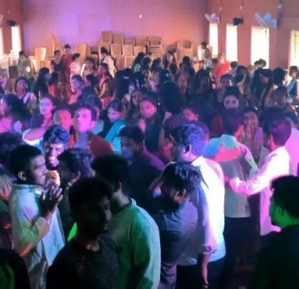 The party is in full swing, with colorful lights and a happy crowd.