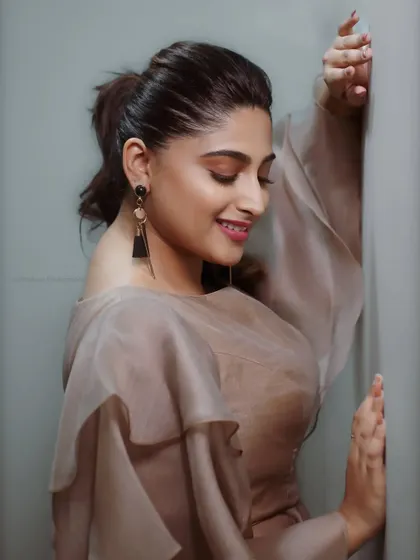 An elegant and soft portrait of actress Nishvika. The gentle lighting and her relaxed expression create a beautiful and timeless image.