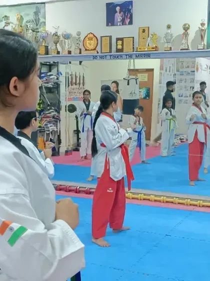 A view of the class from behind a student, showing the mirror that helps with self-correction.