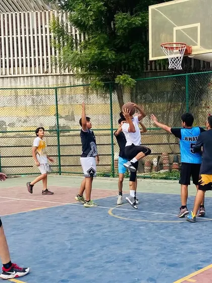 Action under the basket as players fight for a rebound during a senior team game.