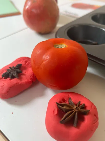During our red-colored exploration, my son also discovered a tomato. We encourage this kind of child-led discovery, allowing him to use the playdough and spices to explore other red objects too.