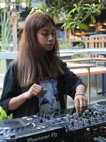 Deep in concentration, finding the perfect next track to keep the energy flowing. I love building a set that takes the crowd on a seamless trip.
