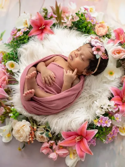 A beautiful baby girl sleeping in a nest of flowers. This is the same sweet moment as my featured photo, showing how we capture different angles to create a full gallery.