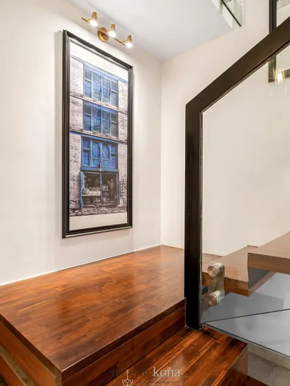Another view of the staircase landing, featuring a large, framed photograph that adds a personal and artistic touch to the space.