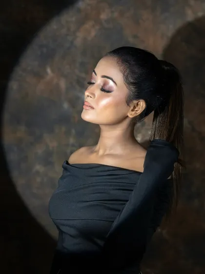 A creative shot using lighting to highlight the beautiful makeup.