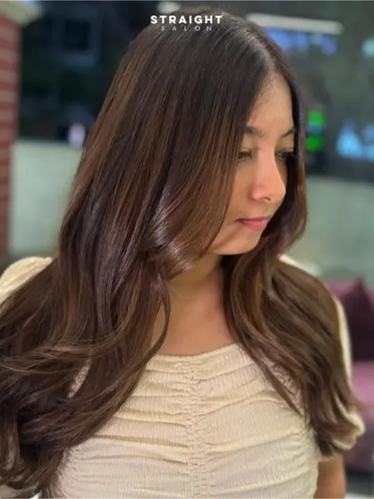 A happy client with her freshly colored and styled hair.