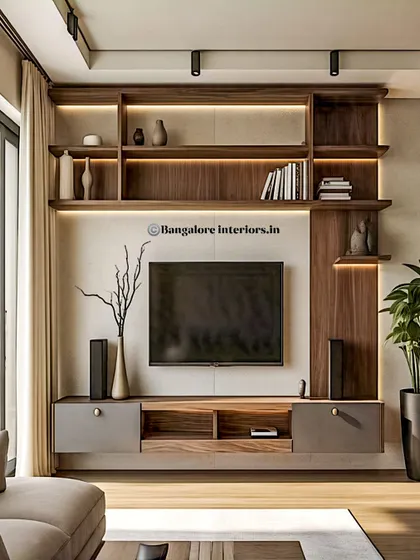 This sleek, modern TV unit uses a combination of dark wood and grey tones. The backlit open shelves provide ambient lighting, while the low-profile console offers practical storage for media devices.