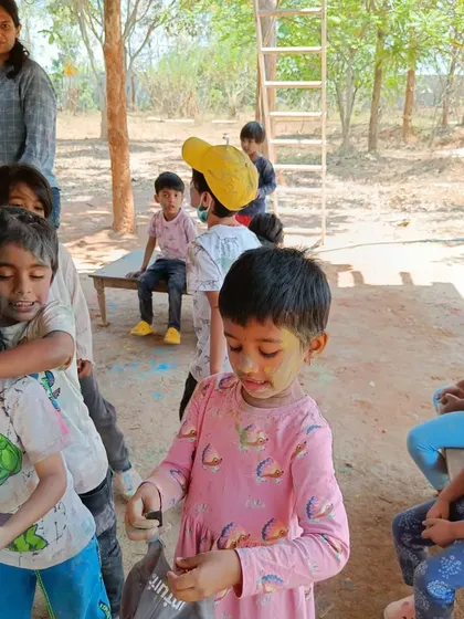 The fun of playing Holi with friends during our farm field trip. These experiences outside the classroom build strong social bonds.