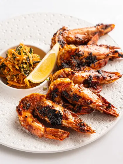 Simply grilled prawns from Gallops. This clean, minimalist shot on a white plate puts all the focus on the perfectly cooked seafood.