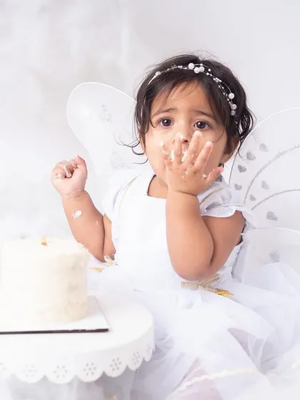 This little fairy is not shy about digging into her cake! I love capturing the moment they decide to go all-in. It's a celebration of their curiosity and spirit.