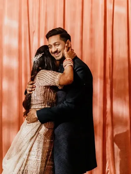 A full, warm hug. The groom smiles contentedly as he holds his bride close. This simple, powerful image speaks volumes about their love and comfort with each other.