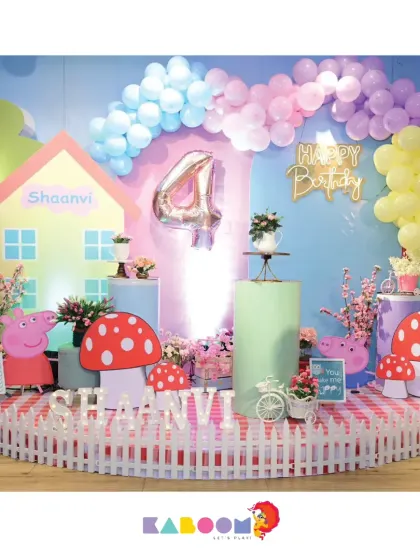 A whimsical Peppa Pig world with a cute house backdrop, mushroom props, and a picket fence. We love adding these little details to make the theme come alive.