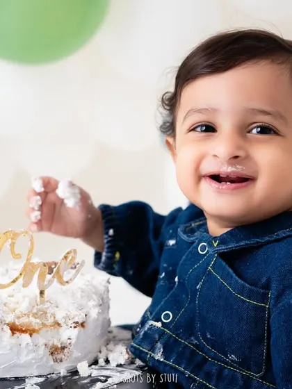 That little smile with a bit of frosting on his fingers says it all. This is the moment of discovery during a cake smash, and it's one of my favorite things to photograph during a first birthday session.