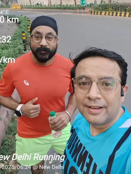 Two members after a 10km run, with their stats displayed. We encourage each other to hit new personal bests.