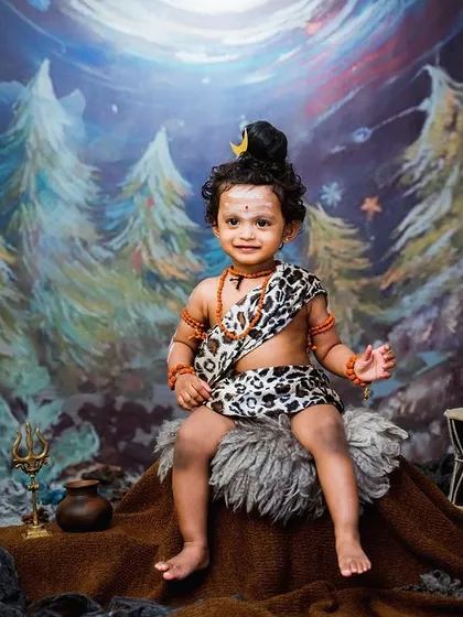 We were so happy to create this powerful portrait of a little one dressed as Lord Shiva. The hand painted backdrop and carefully selected props like the damaru and trishul add a divine touch to the entire composition.