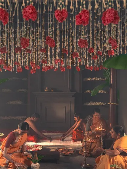 This wide shot shows the beautiful setup for the 'Little Rituals' campaign. The art direction, with the floral ceiling and kolam floor art, created a sacred space for the story of the bridal saree.