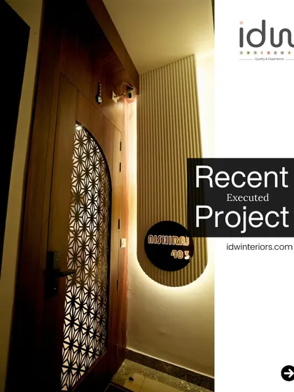 A chic and modern entrance featuring a door with an intricate geometric jaali panel. The backlit nameplate and fluted wall create a high-end, custom look.