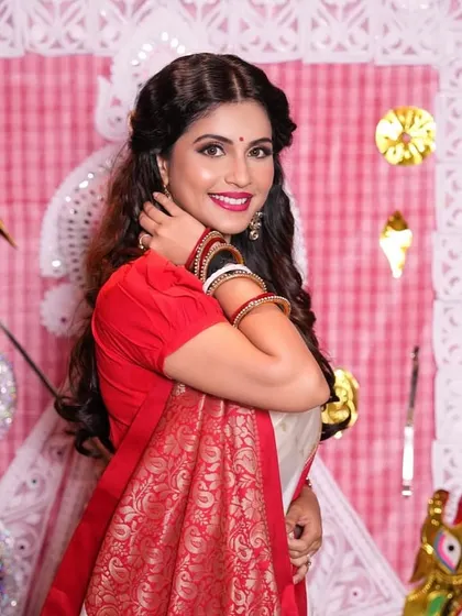 A happy and radiant shot of the Bengali look, showing how the makeup enhances the client's natural smile and features.
