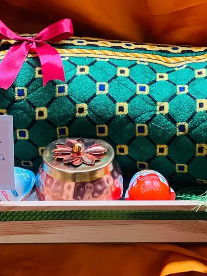 Another shot of the unwrapped thank you hamper, showing the arrangement of the pouch, jar, and flowers on a wooden tray.