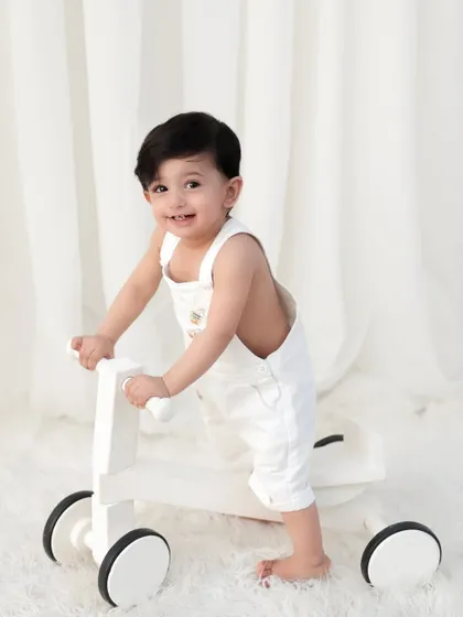 A sweet smile from a little one who is proud of his new walking skills. These milestone moments are so precious to document.