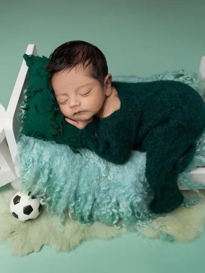 A slightly different composition of the little sports fan, sleeping soundly in a miniature bed. The details, like the tiny sunglasses, add a touch of fun to the setup.