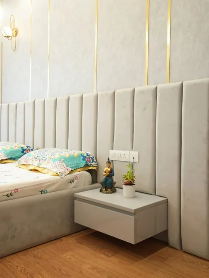 A close-up of the custom floating nightstand that seamlessly blends with the extended grey upholstered headboard, creating a sleek and cohesive design.