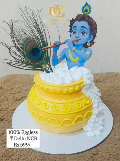 This cake was created for a Janmashtami celebration, featuring a detailed figurine of little Krishna emerging from a pot of butter. The design is complete with a real peacock feather, making it a divine centerpiece for the festival.