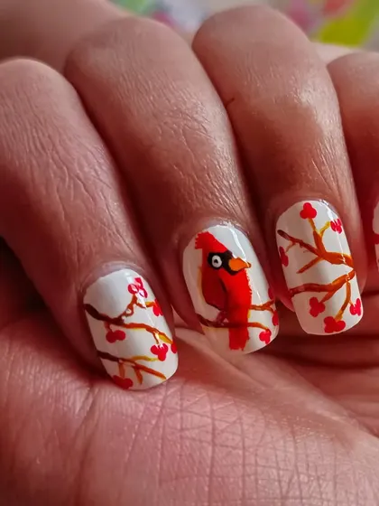 A clearer view of the hand-painted winter berries nail art, showing the fine brushwork involved.