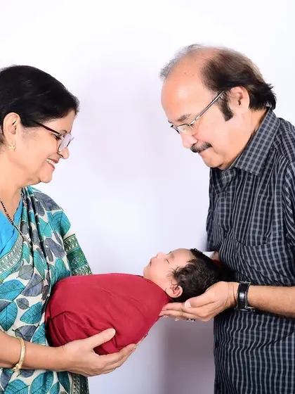 There's a special kind of magic when grandparents hold their grandchild for the first time. This multi-generational portrait captures that priceless, heartwarming bond that your family will cherish for generations to come.