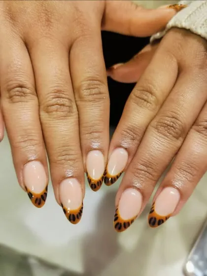 A walk on the wild side. We gave the classic French a fun twist with this hand-painted leopard print design on the tips.