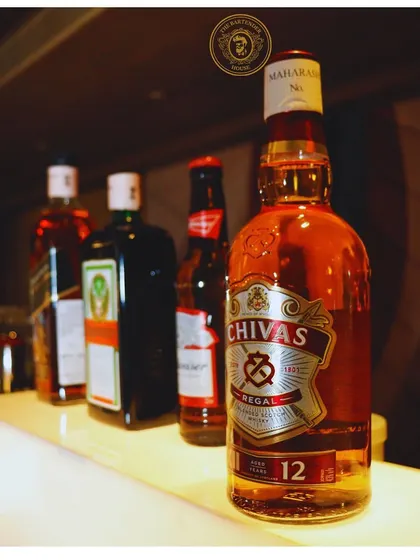 Another view of our well-stocked bar, showcasing a range of premium whiskies and beers. A great party starts with a great selection.