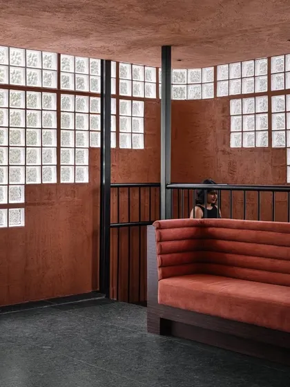 A view of the transition between levels at Idylll, where the earthy tones and textures are consistent, creating a cohesive journey through the space.