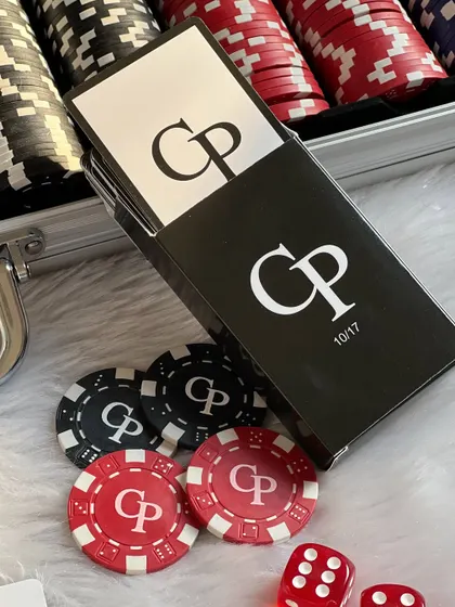 Another detail shot of the personalized poker set, showing the custom-printed box for the playing cards alongside the monogrammed chips.