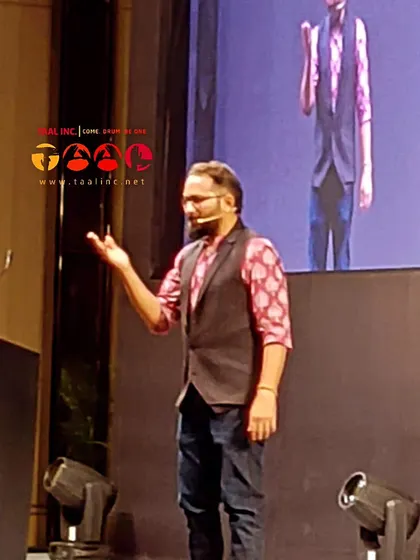 A dynamic shot of our facilitator Aman engaging the audience during a corporate conference. His stage presence is a key part of making these large-scale interactive sessions a success.