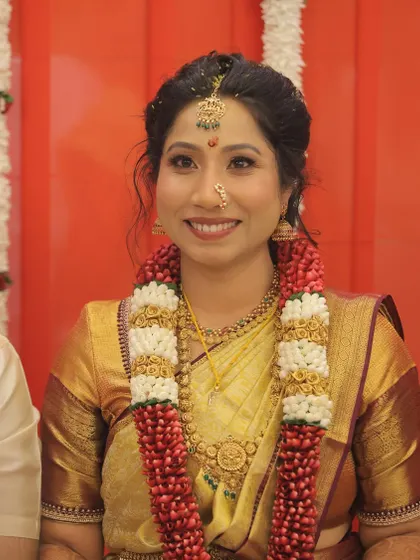 Adorned with garlands, this bride radiates timeless elegance. The makeup is designed to be both beautiful and long-lasting, ensuring she looks fresh and graceful throughout the ceremonies.