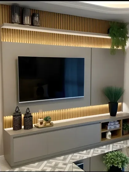 This TV unit uses vertical wooden slats on the top and bottom to create texture and visual interest. The grey floating console offers a sleek storage solution, complemented by integrated backlighting.
