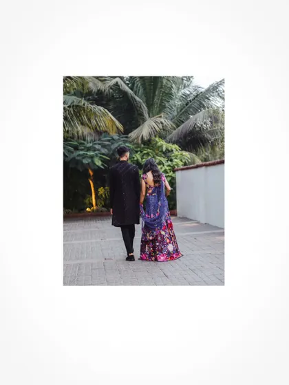 A candid walking shot of the couple at their Sangeet venue.