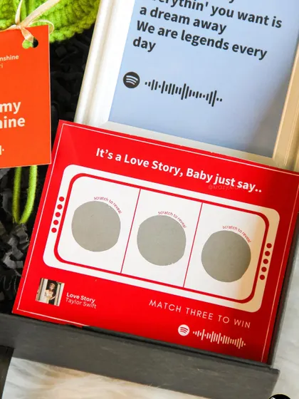 We love interactive elements! This custom scratch card, inspired by Taylor Swift's "Love Story," adds a fun and musical touch to a Valentine's hamper.
