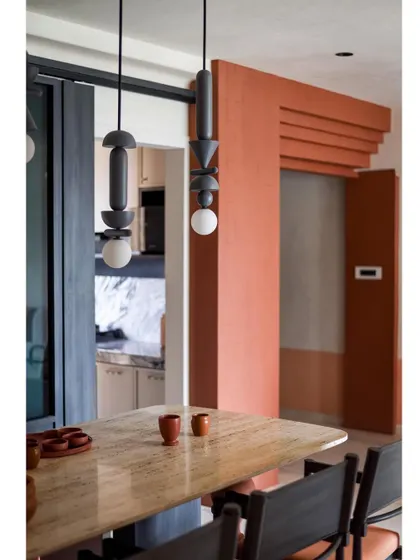 The dining area is a perfect example of how we blend different materials and styles to create a cohesive and inviting space.