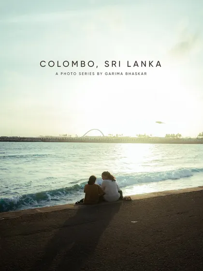 A photo series postcard from Colombo, Sri Lanka. This image captures a quiet moment of two people watching the sunset at the beach, perfectly summarizing the peaceful vibe.