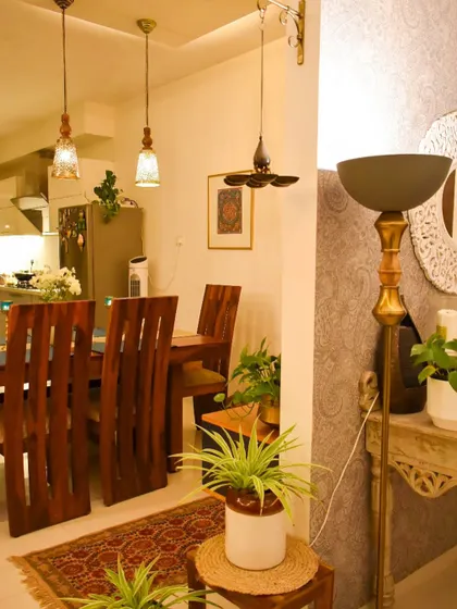 This view shows the dining area in relation to the foyer. The consistent lighting and decor style tie the spaces together.