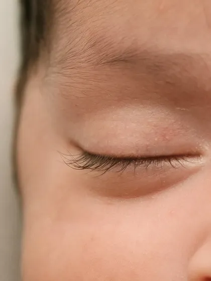 The delicate, feathery eyelashes of a sleeping newborn. These are the details you'll want to gaze at forever.