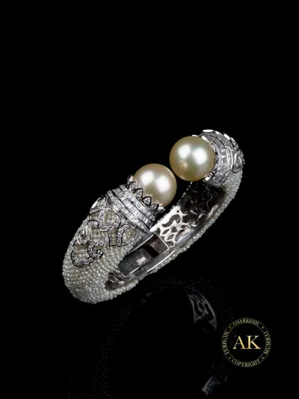 This piece is where regal meets rare. Crafted with hundreds of seed pearls, natural golden South Sea pearls, and a halo of fine diamonds, this is not just a bracelet. It’s a sculpture in motion, designed for collectors of art and emotion.