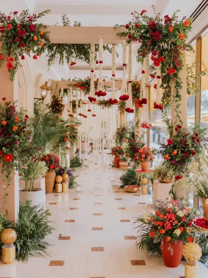 The full view of the Mamera ceremony walkway, adorned with lush floral arrangements and traditional hanging elements.