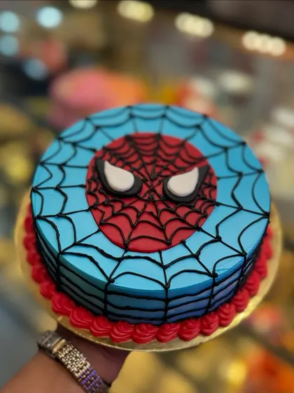 With great cake comes great responsibility. This Spiderman cake features his iconic mask and web design, perfect for a superhero-themed party. The clean lines and bold colors make it instantly recognizable.