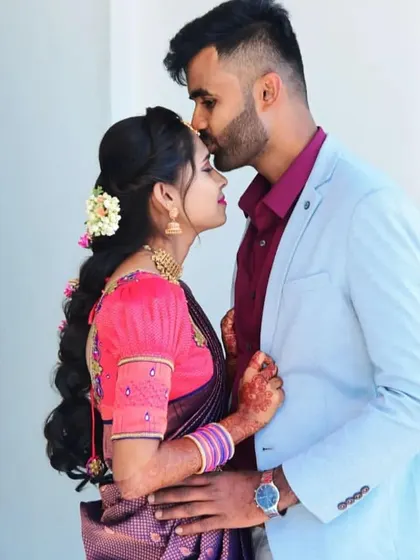 A sweet moment from a pre-wedding shoot. The makeup is soft and romantic, with a focus on flawless skin and a pretty pink lip, ensuring the couple looks their best.