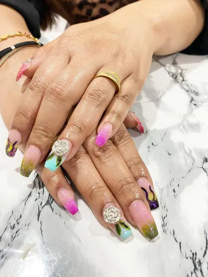 I'm so proud of my students' work. This fantasy nail set with multi-color ombre, flame details, and sculpted 3D roses was created by a student after just three days of training.